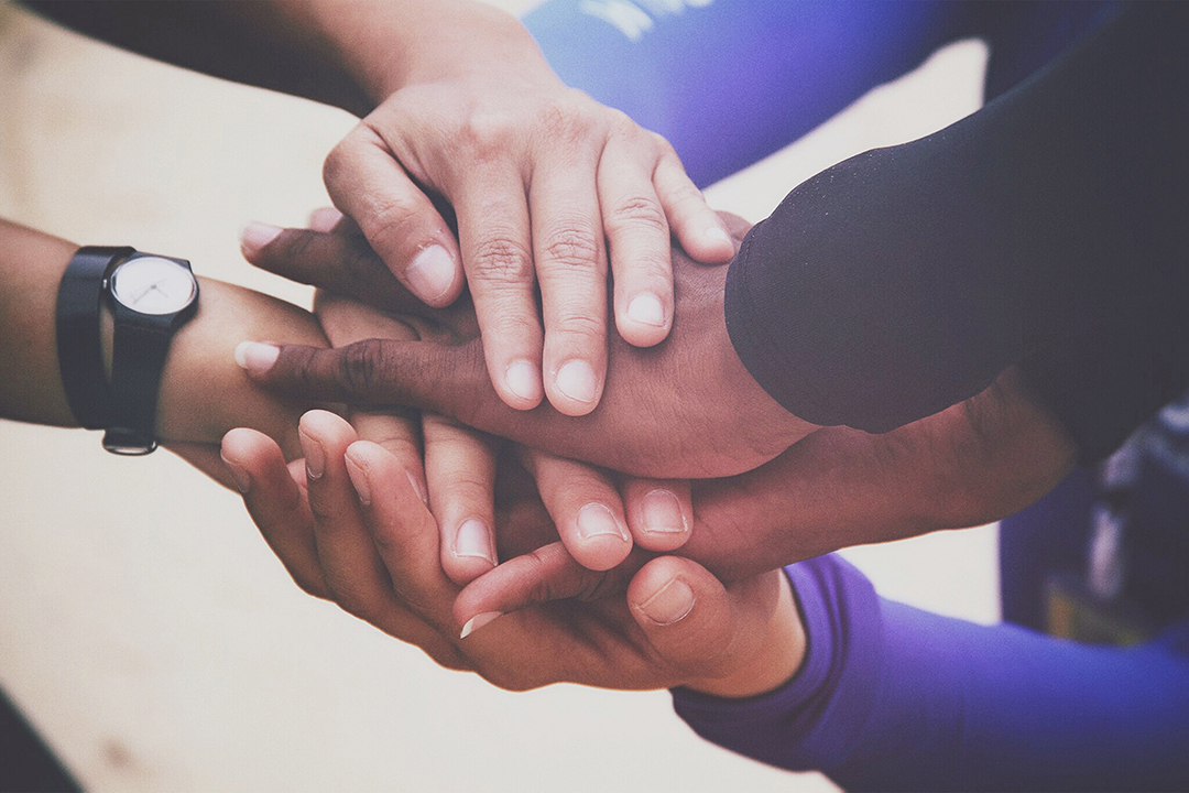 diverse-group-of-people-holding-hands-in-supportiv-2022-04-28-01-41-23-utc.jpg